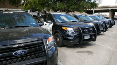 In this Tuesday, July 11, 2017, file photo, Austin police Ford utility vehicles are parked on East Eighth Street outside police headquarters in Austin, Texas. Ford Motor Co. has begun repairing Ford Explorer SUVs in Austin that were pulled off police duty because exhaust containing carbon monoxide was seeping into them. But the company faces lingering questions about the safety of thousands of other Explorers on the road. Ford says it’s still investigating complaints of exhaust fumes in its non-police Explorers.