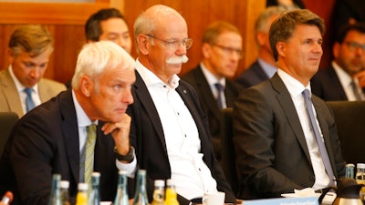 From right to left : Harald Krueger, CEO of German car maker BMW, Dieter Zetsche, chairman of German car maker Daimler AG and head of Mercedes-Benz cars and Matthias Mueller, CEO of German car maker Volkswagen have taken seat to attend a so-called diesel summit on Wednesday, Aug. 2, 2017 in Berlin. German government officials and automakers meet to discuss the future of diesel vehicles, after a nearly two-year saga of scandal spread from Volkswagen to others in the sector.