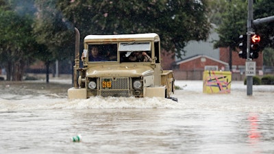 A truck pushes through floodwaters from Tropical Storm Harvey on Sunday, August 27, 2017, in Houston, Texas.