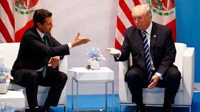 In this July 7, 2017 file photo, U.S. President Donald Trump meets with Mexican President Enrique Pena Nieto at the G20 Summit, in Hamburg. Trump's push to renegotiate the North American Free Trade Agreement is putting Mexico in a tough spot, threatening the system that has helped turn the country into a top exporter through low wages, lax regulations and proximity to the United States. Talks are set for Aug. 16 in Washington D.C.