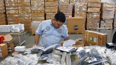 In this Friday, June 2, 2017, file photo, Claudio Montes checks a shipping manifest for U.S. manufactured parts heading to assembly plants in Mexico at Freight Dispatch Service Agency LTD in Pharr, Texas. The freight service ships parts between the U.S. and Mexico that pass through the border freely due to the North American Free Trade Agreement. Of all the trade deals he lambasted on the campaign trail as threats to American workers, President Donald Trump reserved particular scorn for one: NAFTA.
