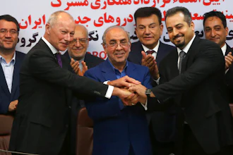 Chief Competitive Officer of Groupe Renault Thierry Bolloré, left, Chairman of Industrial Development and Renovation Oraganization of Iran, IDRO, Mansour Moazami, center, and Negin Group CEO Kourosh Morshed Solouk join hands after signing a deal in Tehran, Iran, Monday, Aug. 7, 2017. Iran signed the country's biggest-ever car deal with French multinational automobile manufacturer Groupe Renault on Monday to produce 150,000 cars, beginning in 2018.