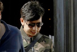 In this April 5, 2017, file photo, Vorayuth 'Boss' Yoovidhya, whose grandfather co-founded energy drink company Red Bull, walks to get in a car as he leaves a house in London. The Bangkok billionaire family uses offshore companies to cloak purchases of jets and luxury properties, including the posh London home where the clan’s fugitive son was last seen. The Yoovidhya family’s efforts to hide assets show how easily major global financial players can routinely - and, usually, legally - move billions of dollars with little or no oversight.