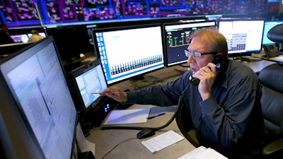 In this Thursday, Aug. 7, 2017 photo, Shift Supervisor Gary Anderson, monitors the power system flow and conditions at the Pacific Gas & Electric grid control center, in Vacaville, Calif. Power grid managers say they've been preparing extensively for more than a year for this Monday's solar eclipse and that by ramping up other sources of power, mainly hydroelectric and natural gas, they are confident nobody will lose power or see a spike in energy prices.