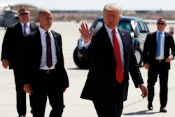 In this Tuesday, Aug. 22, 2017, file photo, President Donald Trump walks with his U.S. Secret Service protective detail as he waves before he departs on Air Force One in Yuma, Ariz. Some local officials in the border city of Yuma have expressed disappointment in the brevity of President Trump's visit, which they were hoping would give the community a higher profile on the national stage. The Yuma Sun reports that the initial plans for Trump's visit included a visit to the border and possible meetings with farmers and local politicians, but that didn't happen.