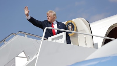 President Donald Trump waves as he boards Air Force One at Andrews Air Force Base, Md., Friday, Aug. 4, 2017, en route to New Jersey to begin his summer vacation at his Bedminster golf club.