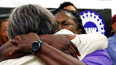 United Auto Workers members, some Nissan employees and supporters console one another as they express their disappointment at losing their bid to form a union at the Nissan vehicle assembly plant in Canton, Miss., Friday, Aug. 4, 2017.