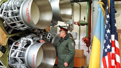 In this Friday, Feb. 26, 1999 file photo, a Ukrainian defense official examines a SS-19 nuclear missile just before it is to be dismantled in the southeastern city of Dnipro, Ukraine. The New York Times reported Monday, Aug. 14, 2017 that Pyongyang's quick progress in making ballistic missiles potentially capable of reaching the United States was made possible by black-market purchases of powerful rocket engines, probably from the Ukrainian plant in Dnipro. Ukrainian officials denied the claim.
