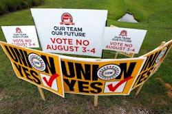 In this Tuesday, Aug. 1, 2017, photo, UAW members use their signs to block Nissan company signs at one of the entrances to the vehicle assembly plant in Canton, Miss. In voting that begins early Thursday, Aug. 3, some 3,700 direct employees at the Nissan plant will decide whether they want a union. The polls close at 7 p.m., local time on Friday.