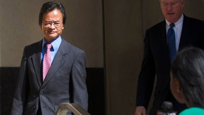 In this Sept. 9, 2016, file photo, Volkswagen engineer James Robert Liang, left, leaves court, in Detroit, after pleading guilty to one count of conspiracy in the company's emissions cheating scandal. U.S. prosecutors are seeking a three-year prison sentence for a Volkswagen engineer who had a key role in the company's diesel emissions scandal. Liang is scheduled to be sentenced Friday, Aug. 25, 2017, in Detroit federal court. He is one of two VW employees to plead guilty, although others charged in the case are in Germany and out of reach.