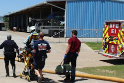 In this April 29, 2014, photo provided by the Bryan, Texas, Fire Department, firefighters transport an injured worker in a stretcher to the ambulance. An explosion at the Bryan Texas Utilities Power Plant left Earle Robinson, 60, dead and two others injured. Older people are dying on the job at a higher rate than workers overall, even as the rate of workplace fatalities decreases, according to an Associated Press analysis of federal statistics.