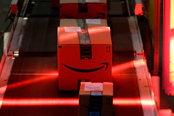 In this Tuesday, Aug. 1, 2017, photo, packages riding on a belt are scanned to be loaded onto delivery trucks at the Amazon Fulfillment center in Robbinsville Township, N.J. Amazon is holding a giant job fair Wednesday, Aug. 2, and plans to make thousands of job offers on the spot at nearly a dozen U.S. warehouses.