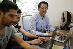 In this Friday, July 14, 2017, photo, computer scientist Andrew Ng, right, works with others at his office in Palo Alto, Calif. Ng, one of the world's most renowned researchers in machine learning and artificial intelligence, is facing a dilemma: there aren't enough experts trained to train the machines. So when he isn't pushing into the frontier of AI himself, Ng is building new ways to help educate the next generation of AI specialists.