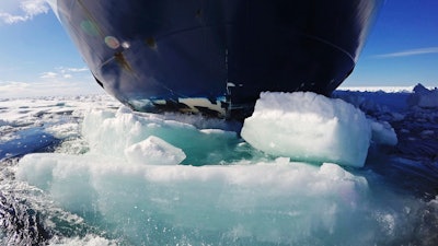 The bow of the Finnish icebreaker MSV Nordica pushes down sea ice as it traverses the Arctic's Northwest Passage through the Canadian Arctic Archipelago, Friday, July 21, 2017. Sailing through the Northwest Passage could potentially cut the distance from East Asia to Western Europe by more than 10,000 kilometers (6,200 miles), compared with the traditional route through the Panama Canal, offering huge fuel savings for thirsty ships. But it's not without hurdles.