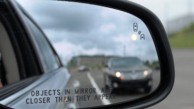 In his May 22, 2012 file photo, a side mirror warning signal in a Ford Taurus at an automobile testing area in Oxon Hill, Md. Safety systems to prevent cars from drifting into another lane or warn drivers of vehicles in their blind spots are beginning to live up to their potential to significantly reduce crashes, according to two studies released Wednesday, Aug. 23, 2017.