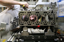 A Ford employee quality checks cylinder holes of a two liter diesel engine, at the Ford Dagenham diesel engine plant in London, Friday, July 21, 2017. Ford’s Dagenham diesel engine plant is a marvel of mechanization _ a steel and chrome hangar full of LED lighting, robots and computer-controlled machine tools. The U.S. carmaker has invested $2.5 billion in the plant, where 3,150 people churn out an engine every 30 seconds.