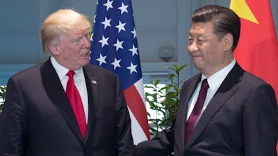 In this Saturday, July 8, 2017, file photo, U.S. President Donald Trump, left, and Chinese President Xi Jinping arrive for a meeting on the sidelines of the G-20 Summit in Hamburg, Germany.