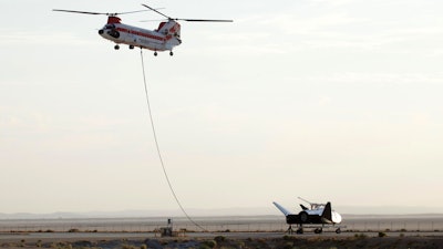 Sierra Nevada Corp's 'Dream Chaser' test spacecraft is prepared to be lifted by a helicopter for a test at Edwards Air Force Base, Calif. on Wednesday, Aug. 30, 2017.