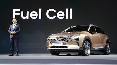 Hyundai Motor Co.'s Director Ryu Chang-sung speaks near Hyundai Motors' new hydrogen fuel cell vehicle during a media preview in Seoul, South Korea, Thursday, Aug. 17, 2017. Hyundai Motor says its new hydrogen fuel cell vehicle will travel more than 580 kilometers (360 miles) between fill-ups.