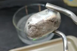 A researcher holds up a piece of magnesium.