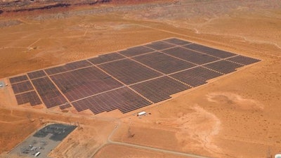 This Aug. 24, 2017, photo provided by Navajo Nation Office of the President and Vice President shows solar panels near famed sandstone buttes along the Arizona-Utah border on the Navajo Nation.