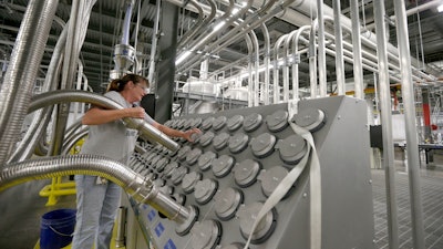 In this Friday, Oct. 21, 2016, file photo, Susan Stacy moves a tube to sort recycled plastic bottle chips being processed at the Repreve Bottle Processing Center, part of the Unifi textile company in Yadkinville, N.C. On Thursday, Aug. 3, 2017, the Commerce Department reports on U.S. factory orders for June.