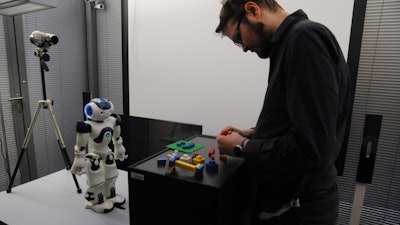 One of the study participants interacting with the robot during the experiment.