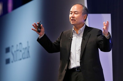 In this July 20, 2017 photo, SoftBank Group Corp. Chief Executive Officer Masayoshi Son speaks during a SoftBank World presentation in Tokyo. SoftBank said Monday, Aug. 7, 2017 its quarterly net profit was 5.5 billion yen ($50 million), down from 254 billion yen the previous year. Quarterly sales added 3 percent to 2.19 trillion yen ($20 billion).