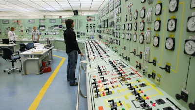 In this Oct. 6, 2009 file photo, of a worker as he checks the controls inside the control room of the nuclear power plant of Santa Maria de Garona in Spain. The Spanish government said on Tuesday Aug. 1, 2017 that it is closing the country's oldest nuclear power station Santa Maria de Garona, because of lack of support among political parties and companies involved to keep it open and uncertainty surrounding the plant's viability.