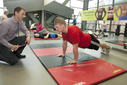 UC professor Jason Heikenfeld works with a research subject while developing biosensors that use sweat to monitor health and wellness.