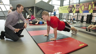 UC professor Jason Heikenfeld works with a research subject while developing biosensors that use sweat to monitor health and wellness.