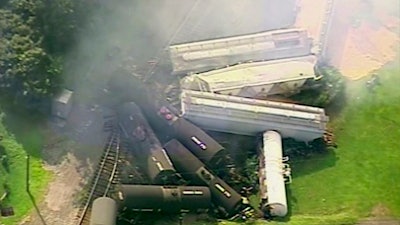 In this Aug. 2, 2017, file aerial image made from a video provided by WPXI, smoke rises in the air after dozens of cars of a freight train carrying hazardous materials derailed in Hyndman, Pa.