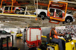 Vehicles are suspended above other installation stations as they are moved along the assembly line at the Nissan Canton Vehicle Assembly Plant.