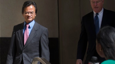 In this Sept. 9, 2016, file photo, Volkswagen engineer James Robert Liang, left, leaves court, in Detroit, after pleading guilty to one count of conspiracy in the company's emissions cheating scandal. U.S. prosecutors are seeking a three-year prison sentence for a Volkswagen engineer who had a key role in the company's diesel emissions scandal. Liang is scheduled to be sentenced Friday, Aug. 25, 2017, in Detroit federal court. He is one of two VW employees to plead guilty, although others charged in the case are in Germany and out of reach.