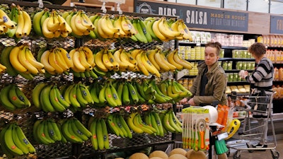 In this May 3, 2017, file photo, customers shop at a Whole Foods Market in Upper Saint Clair, Pa. Amazon is moving swiftly to make big changes at Whole Foods.