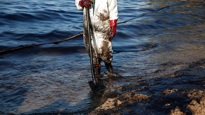 A workers cleans a beach of an oil spillage at Faliro suburb, near Athens.