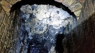 In this undated handout photo issued by Thames Water on Tuesday, Sept. 12, 2017, a view of a fatberg inside a sewer in Whitechapel, London. British engineers say they have launched a “sewer war” against a giant fat blob clogging London’s sewers. Thames Water officials said Tuesday it is likely to take three weeks to dissolve the outsize fatberg.