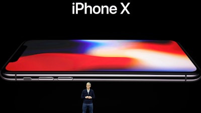 Apple CEO Tim Cook announces the new iPhone X at the Steve Jobs Theater on the new Apple campus, Tuesday, Sept. 12, 2017, in Cupertino, Calif.