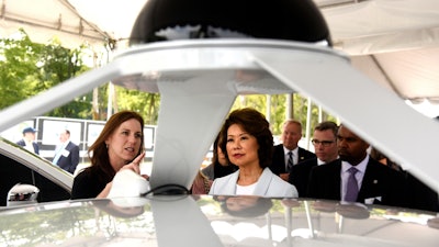 U.S. Transportation Secretary Elaine Chao, right, looks at the Lidar system with Jill Sciarappo, senior director, Intel Automated Driving Group, Tuesday, Sept. 12, 2017, at the University of Michigan, in Ann Arbor, Mich., where she announced new voluntary safety guidelines for self-driving cars during a visit to an autonomous vehicle testing facility at the school. The new guidelines update policies issued last fall by the Obama administration, which were also largely voluntary.