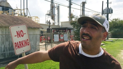 In this Sept. 2, 2017 photo, community environmental activist Juan Flores talks to a reporter in Galena Park, Texas. Petrochemical corridor residents say air that is bad enough on normal days got unbearable as Harvey crashed into the nation's fourth-largest city and then yielded the highest ozone pollution of the year anywhere in Texas.