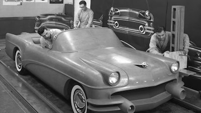 This 1954 photo Courtesy of General Motors shows Buick Design Studio creative clay sculptors as they mold the clay on a model GM automobile.