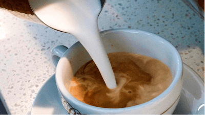 In this photo taken Friday, Sept. 22, 2017, a barista pours steamed milk in a coffee at a cafe in Los Angeles. In a long-running court case playing out in a Los Angeles courtroom, a nonprofit has been presenting evidence to show that coffee companies should post ominous warning labels about a cancer-causing chemical in every cup.