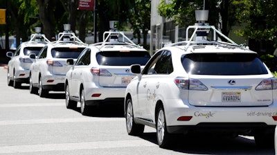 This May 13, 2014, file photo shows a row of Google self-driving Lexus cars at a Google event outside the Computer History Museum in Mountain View, Calif. The House voted Wednesday, Sept. 6, 2017, to speed the introduction of self-driving cars by giving the federal government authority to exempt automakers from safety standards not applicable to the technology, and to permit deployment of up to 100,000 of the vehicles annually over the next several years.