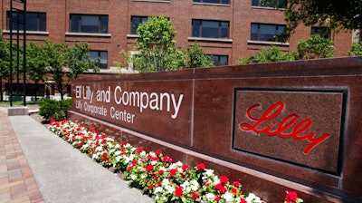 In this June 30, 2011 file photo, a sign from of the Eli Lilly and Co corporate headquarters is pictured in Indianapolis. Eli Lilly will slash its global workforce by nearly 9 percent as the drugmaker closes some research sites and pushes to trim fixed costs. The Indianapolis company said Thursday, Sept. 7, 2017, it will cut about 3,500 positions, mostly through a voluntary retirement program in the United States. The insulin maker employed 41,240 people worldwide at the end of June.