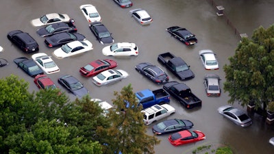 This Tuesday, Aug. 29, 2017, photo shows flooded cars near the Addicks Reservoir as floodwaters from Harvey rise in Houston. Auto industry experts estimate that 500,000 to 1 million cars, trucks and SUVs were damaged by floodwaters from Hurricane Harvey. Most will have so much water damage that they can’t be fixed, and insurance companies will declare them total losses. Yet the damaged cars could be retitled and sold to unsuspecting buyers nationwide. Experts warn against buying the cars because damage could be hidden for years before causing problems.