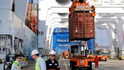 In this Oct. 24, 2016, photo, a container is unloaded from a ship at the Port of Baltimore in Baltimore. On Wednesday, Sept. 6, 2017, the Commerce Department reports on the U.S. trade gap for July.