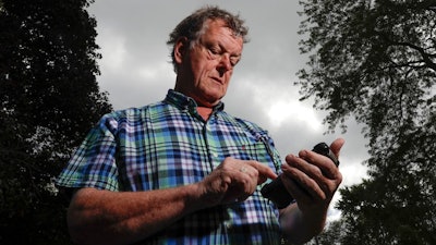 Towne & Country Building Inspection owner Scot McLean looks at his calendar outside his Fox Point, Wis., home Wednesday, Sept. 27, 2017. Towne & Country downloaded several apps to enhance the Google calendar the company uses for customer appointments. In July, McLean noticed some glitches with his Google calendar. McLean's staffer in charge of technology determined that the apps were vulnerable to hacking, and someone was able to log in and erase the appointments.