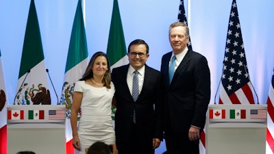 Canadian Foreign Affairs Minister Chrystia Freeland, from left, Mexico's Secretary of Economy Ildefonso Guajardo Villarreal, and U.S. Trade Representative Robert Lighthizer, pose for a group photo at a press conference regarding the second round of NAFTA renegotiations in Mexico City. Tuesday, Sept. 5, 2017.
