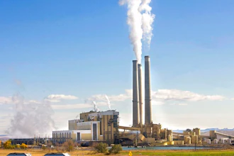 In this Oct. 23, 2009, file photo, coal trucks leave the coal-fired Hunter Power Plant just south of Castle Dale, Utah, after making a delivery. An appeals court has granted a request from President Donald Trump's administration to halt a plan for new pollution controls at Utah's oldest coal-fired power plants aimed at reducing haze near national parks.