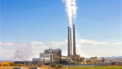 In this Oct. 23, 2009, file photo, coal trucks leave the coal-fired Hunter Power Plant just south of Castle Dale, Utah, after making a delivery. An appeals court has granted a request from President Donald Trump's administration to halt a plan for new pollution controls at Utah's oldest coal-fired power plants aimed at reducing haze near national parks.